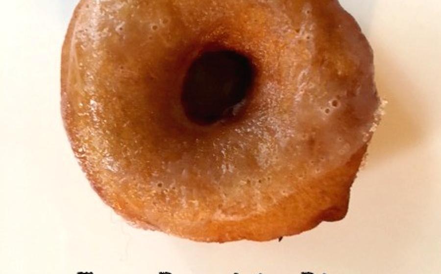 Glazed donut with the words Easy Pumpkin Pie Maple Glazed Donuts