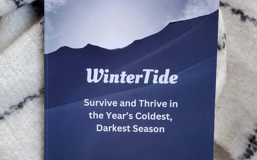 Book cover of WinterTide on top of a fuzzy white wool scarf